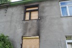 Cleaning the outer wall of the burned house